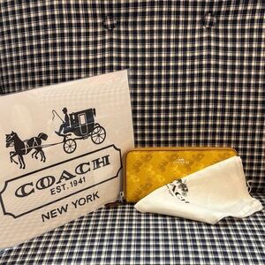 Coach Mustard Yellow Zip-Around Wallet with repeating horse and carriage design
